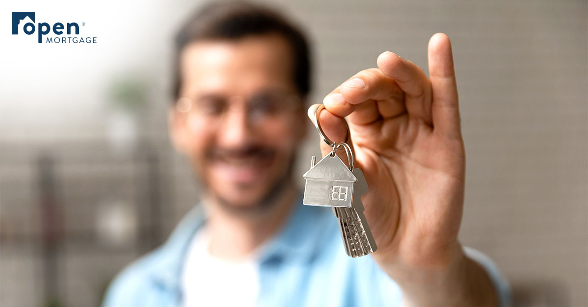 Guy holding house keys